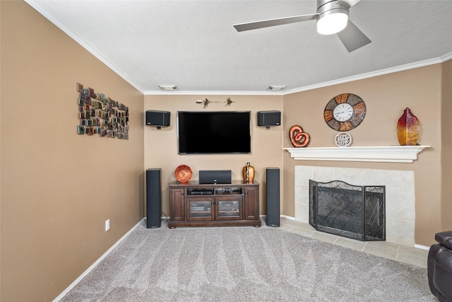 living room featuring crown molding, a fireplace, ceiling fan, and light colored carpet