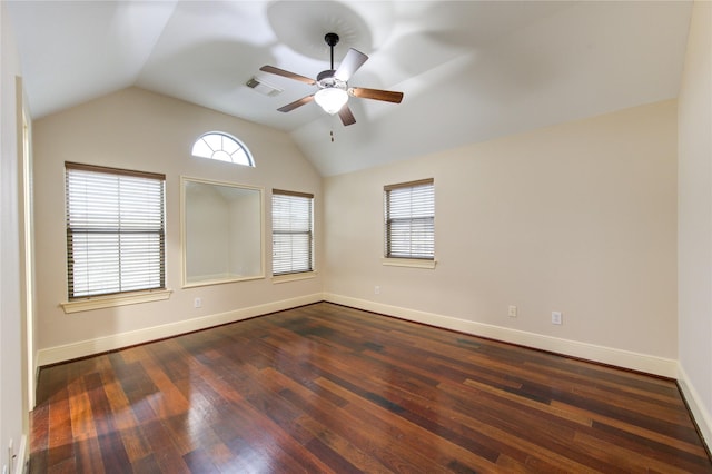 spare room with ceiling fan, plenty of natural light, lofted ceiling, and dark wood-type flooring