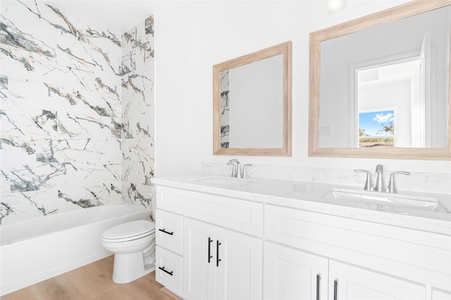 full bathroom with vanity, wood-type flooring, bathtub / shower combination, and toilet