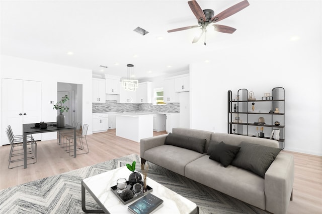 living room featuring ceiling fan and light wood-type flooring