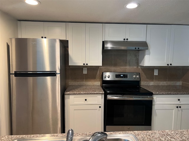 kitchen with backsplash, white cabinets, and stainless steel appliances