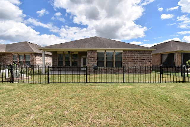 rear view of house featuring a yard and ceiling fan