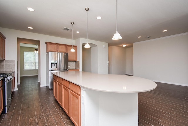 kitchen featuring backsplash, decorative light fixtures, a kitchen island, and stainless steel appliances