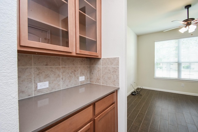 kitchen featuring tasteful backsplash, ceiling fan, and dark wood-type flooring