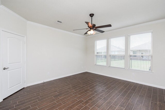 empty room featuring ceiling fan, crown molding, and dark wood-type flooring