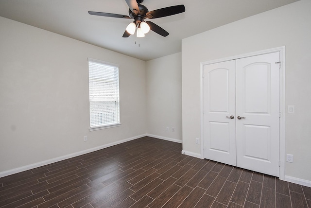 unfurnished bedroom with ceiling fan and a closet