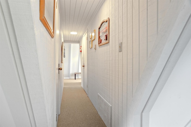 hallway with light colored carpet