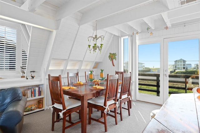 dining area featuring carpet flooring, beam ceiling, and plenty of natural light