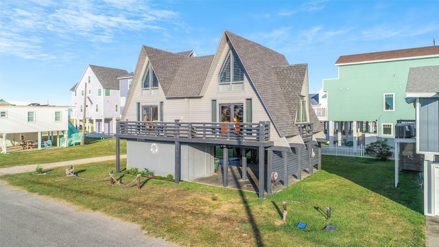 rear view of property featuring a lawn and a wooden deck