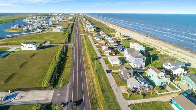 drone / aerial view featuring a beach view and a water view