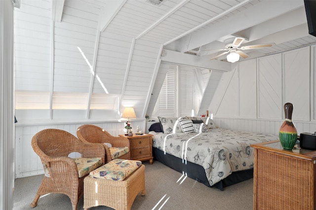 bedroom featuring beamed ceiling, carpet, and ceiling fan