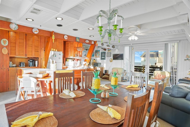 dining room featuring ceiling fan and wood walls