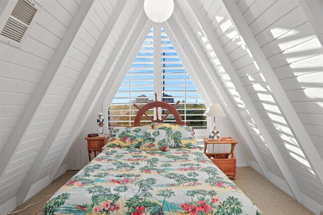 carpeted bedroom featuring vaulted ceiling with beams