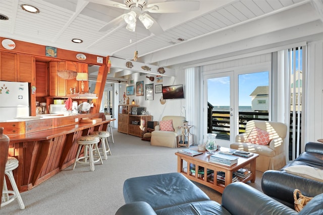 carpeted living room with ceiling fan and wood ceiling