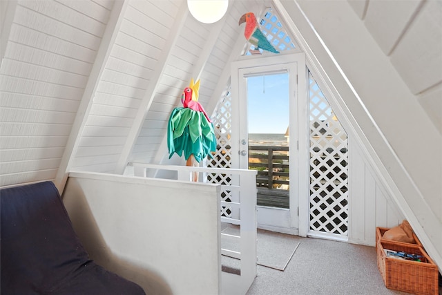 interior space featuring vaulted ceiling with beams, light carpet, and plenty of natural light