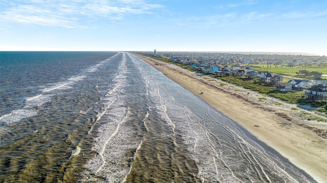 aerial view featuring a view of the beach and a water view