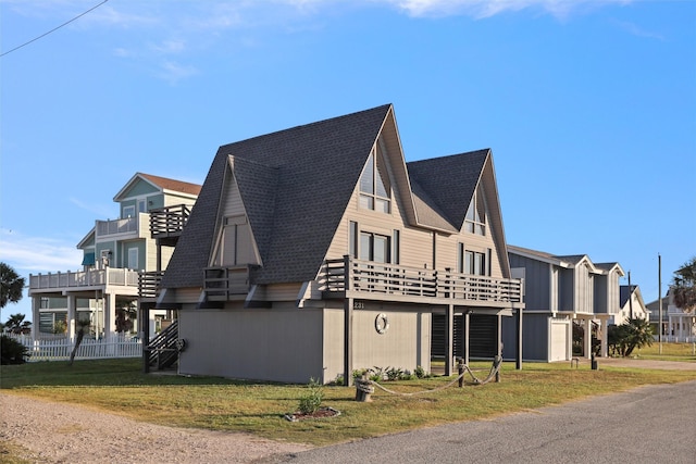 view of side of home featuring a lawn and a balcony