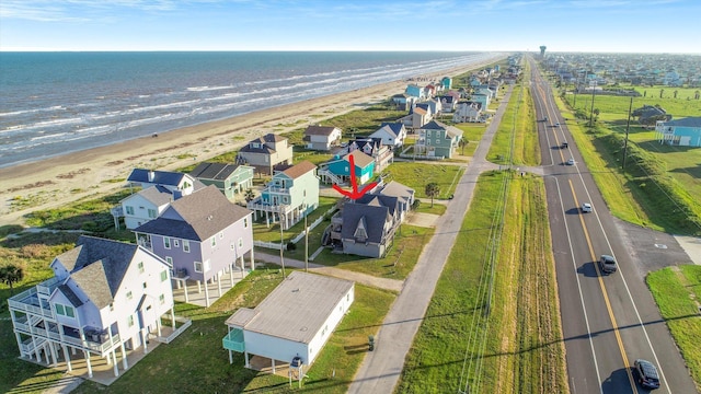 bird's eye view featuring a water view and a beach view