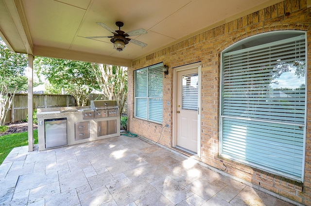 view of patio featuring an outdoor kitchen, ceiling fan, and area for grilling