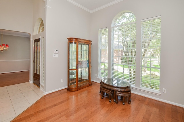 interior space with an inviting chandelier and ornamental molding