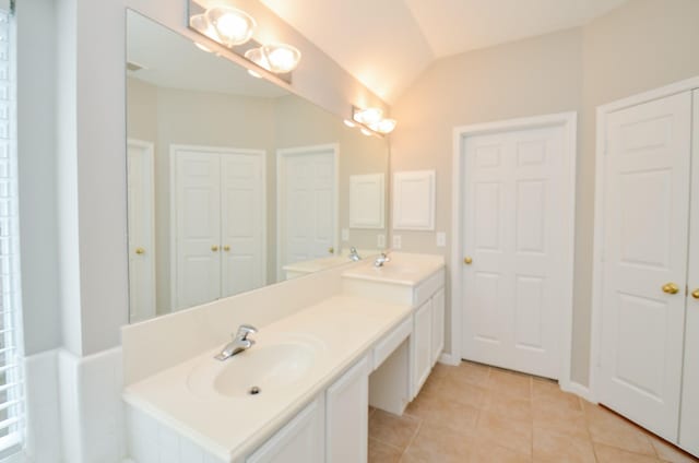 bathroom featuring tile patterned floors, vanity, and lofted ceiling