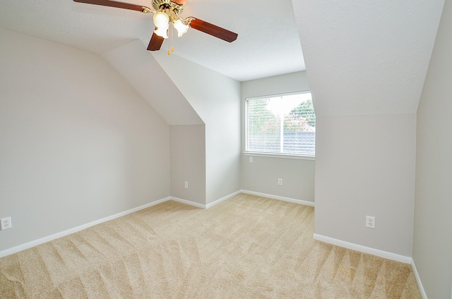 bonus room featuring a textured ceiling, light colored carpet, ceiling fan, and lofted ceiling