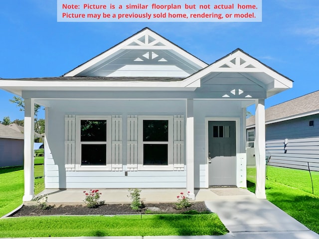 view of front of home with a front lawn and covered porch