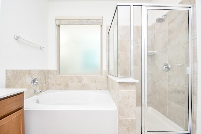 bathroom with vanity and independent shower and bath