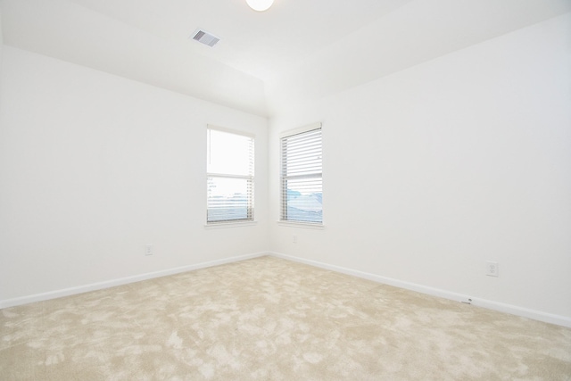 unfurnished room featuring light carpet, baseboards, and visible vents