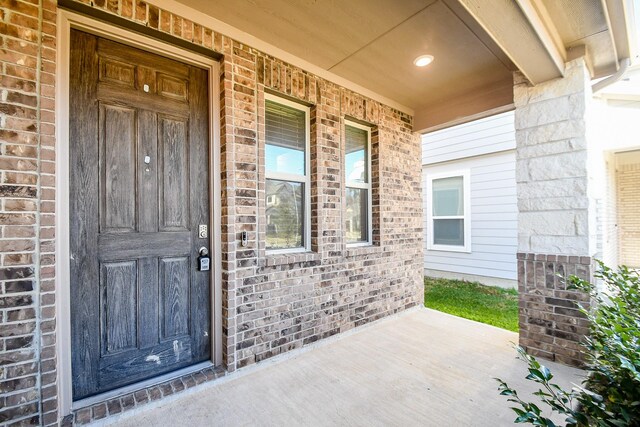 view of exterior entry featuring a porch