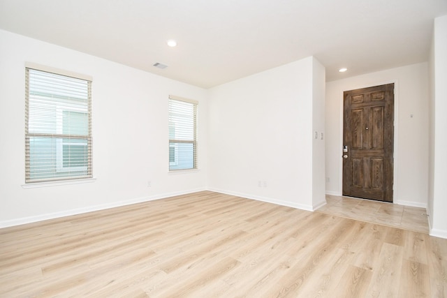 unfurnished room with light wood-type flooring