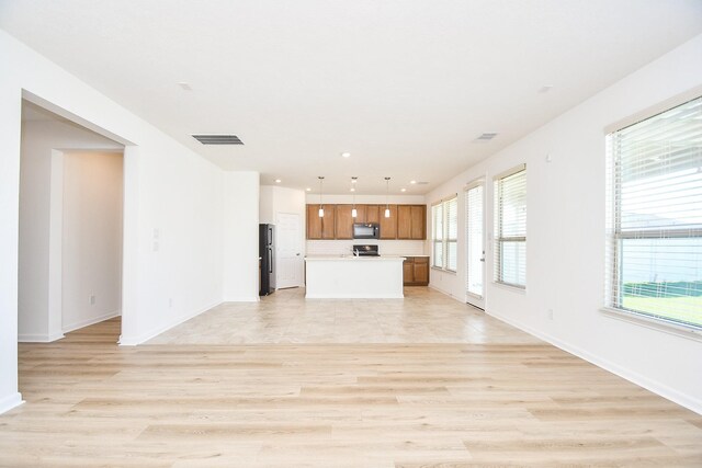 unfurnished living room featuring light wood-type flooring