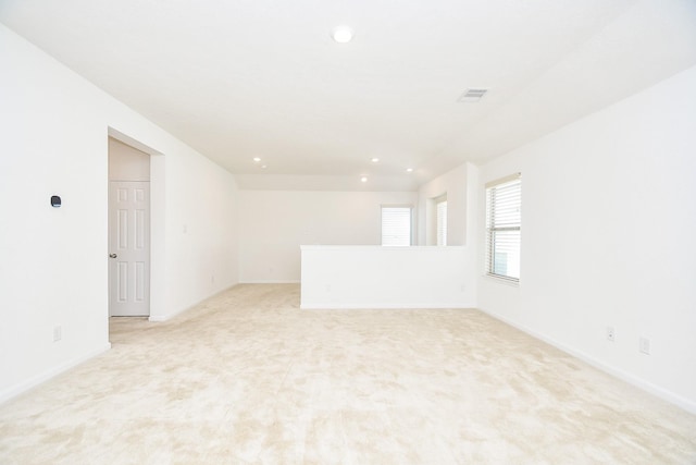 unfurnished room featuring recessed lighting, visible vents, light carpet, and baseboards