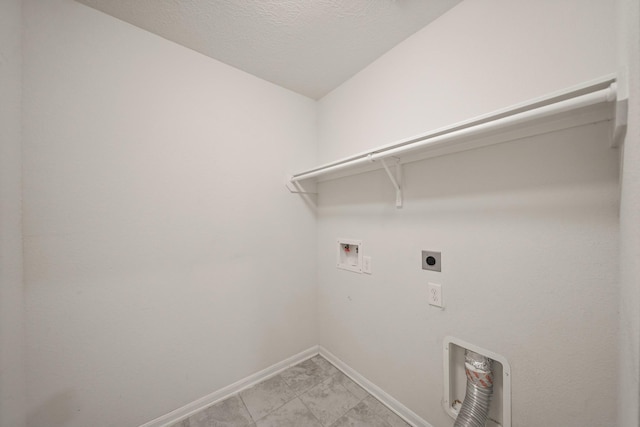 clothes washing area featuring electric dryer hookup, hookup for a washing machine, and a textured ceiling