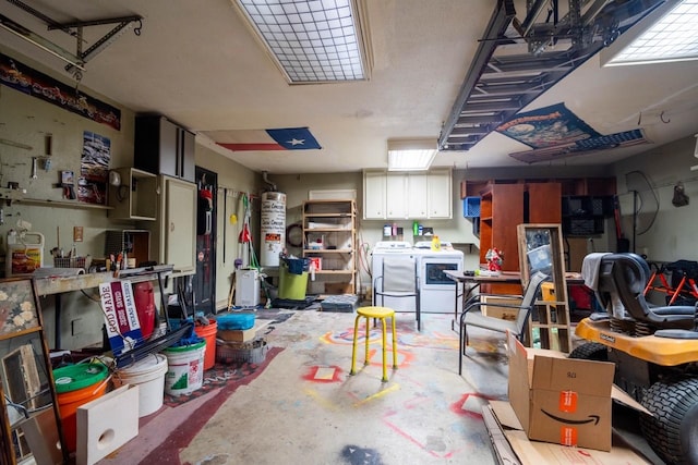 interior space featuring a workshop area, gas water heater, and independent washer and dryer