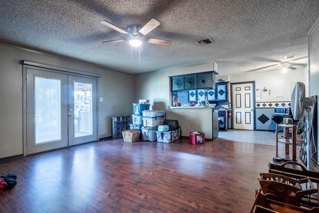 interior space featuring french doors, dark wood-type flooring, and a textured ceiling