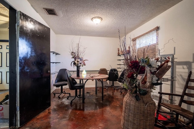 dining area featuring a textured ceiling