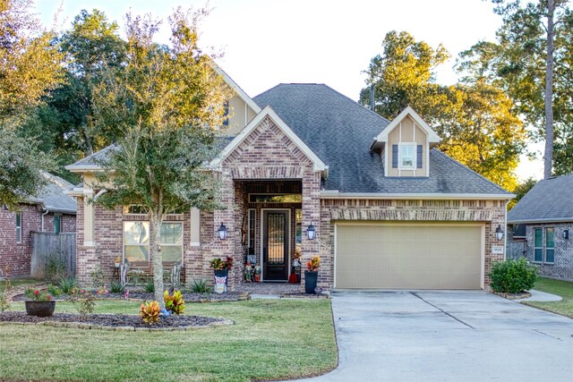 view of front of home featuring a front yard and a garage