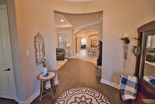 hallway featuring ornamental molding and dark hardwood / wood-style floors