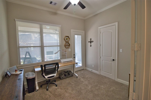 carpeted home office featuring ceiling fan and crown molding