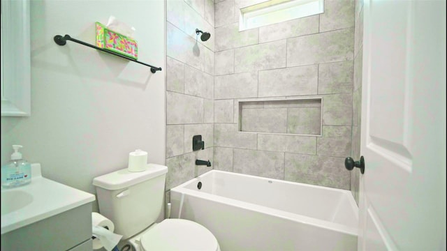 full bathroom with tiled shower / bath combo, toilet, and vanity