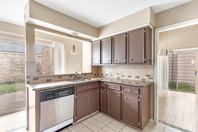 kitchen with dishwasher, dark brown cabinets, sink, and tasteful backsplash