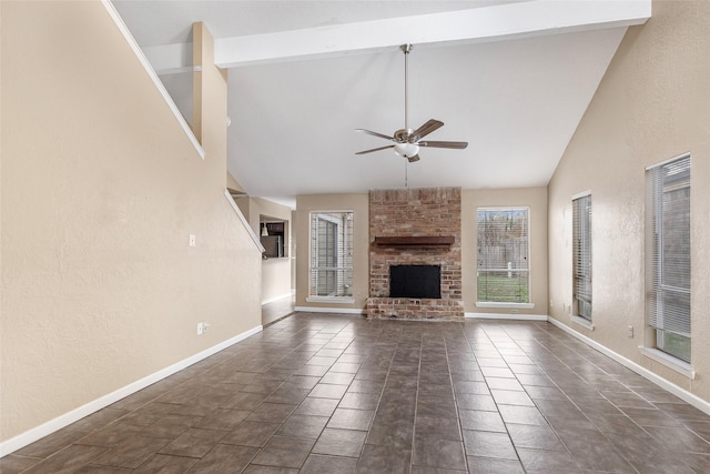 unfurnished living room featuring beamed ceiling, high vaulted ceiling, a brick fireplace, and ceiling fan