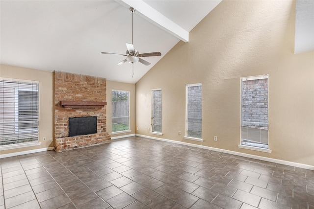 unfurnished living room featuring a brick fireplace, ceiling fan, dark tile patterned flooring, high vaulted ceiling, and beamed ceiling