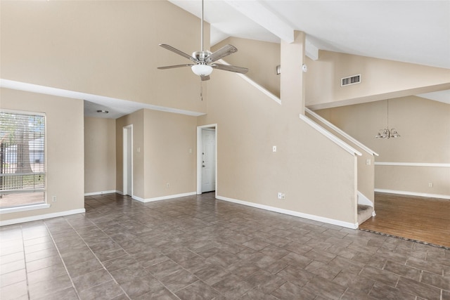 unfurnished living room featuring ceiling fan with notable chandelier and high vaulted ceiling