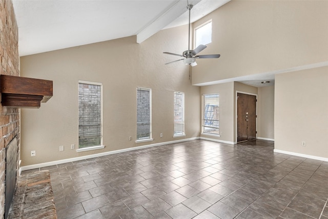 unfurnished living room with ceiling fan, a fireplace, beamed ceiling, and high vaulted ceiling