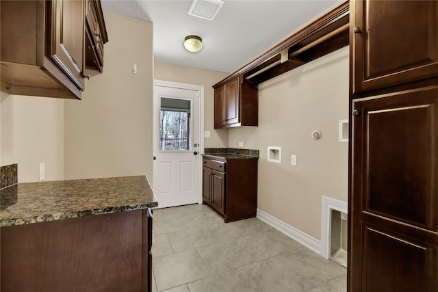 kitchen featuring dark brown cabinets and light tile patterned floors