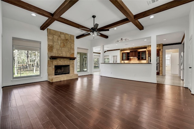 unfurnished living room with beam ceiling, a fireplace, and coffered ceiling