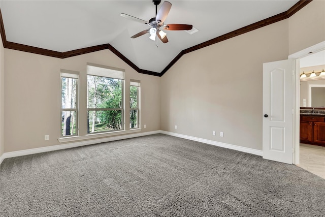 carpeted empty room featuring ceiling fan, sink, lofted ceiling, and crown molding