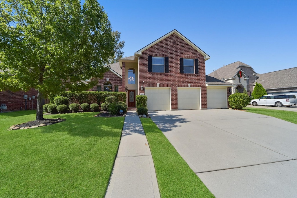 front of property featuring a garage and a front lawn